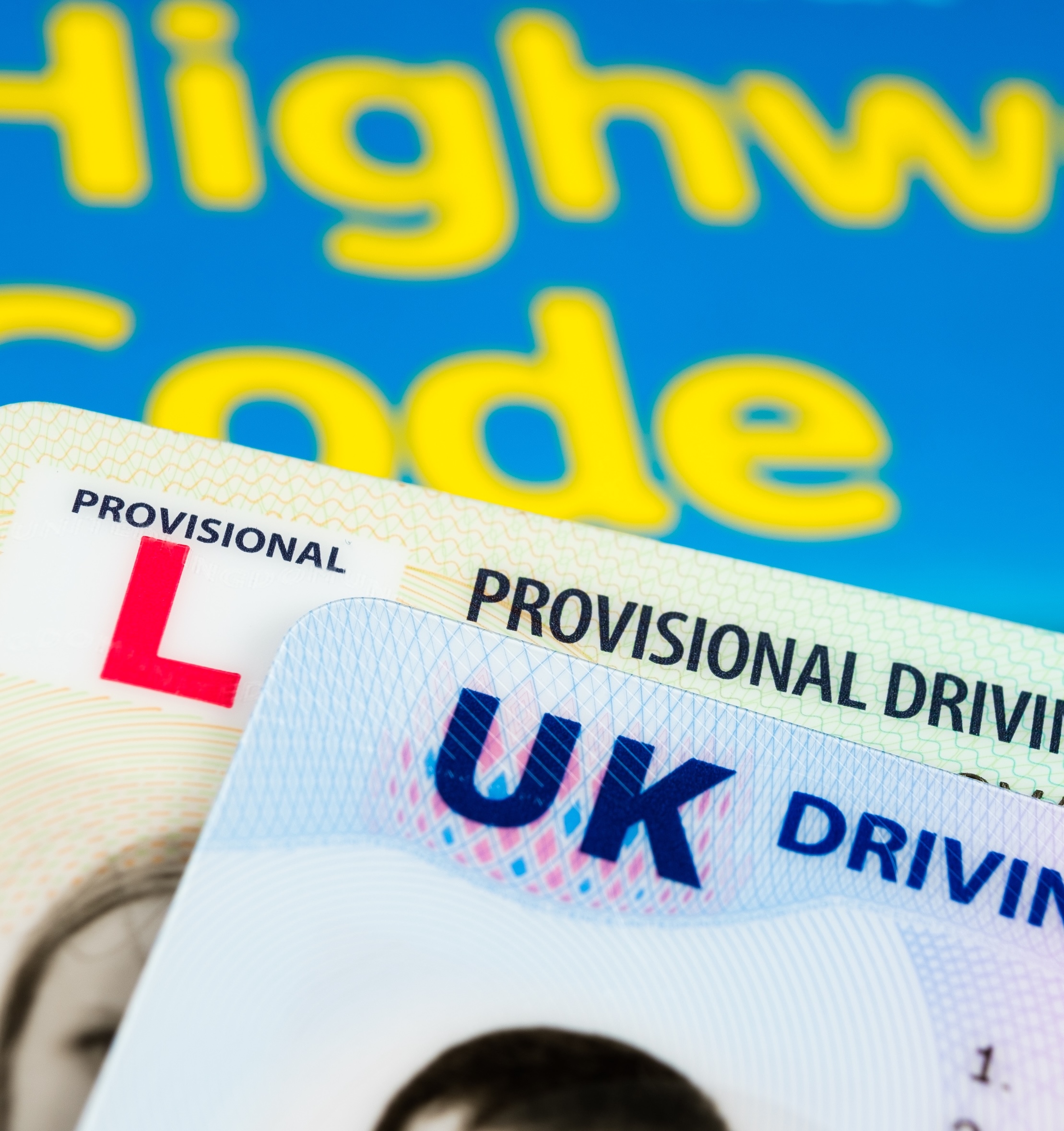 UK Driving Licence. Provisional and Full licence cards placed on Highway Code book. Stafford, United Kingdom